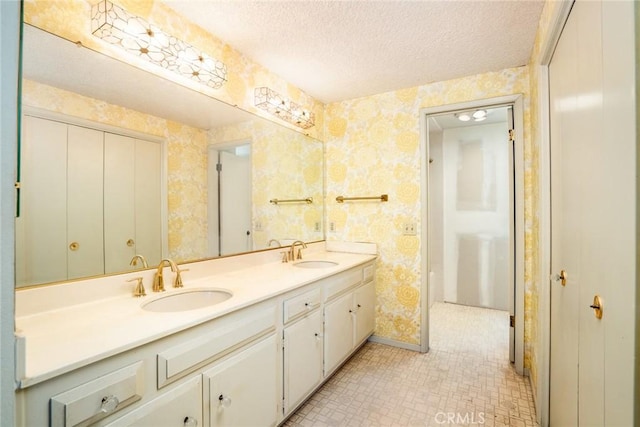 448 Via El Chico, Redondo Beach, CA 90277 - bathroom featuring wallpapered walls, double vanity, a textured ceiling, and tile patterned flooring