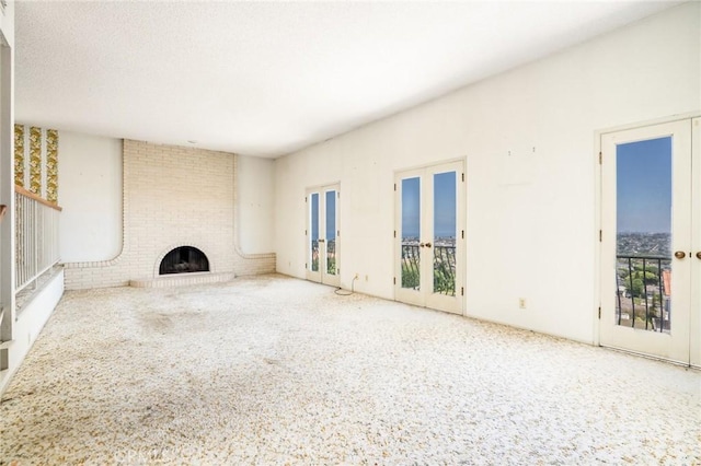 448 Via El Chico, Redondo Beach, CA 90277 - unfurnished living room with french doors, carpet, and a fireplace