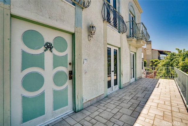 448 Via El Chico, Redondo Beach, CA 90277 - property entrance with a balcony, french doors, and stucco siding