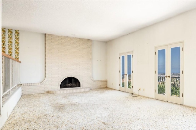 448 Via El Chico, Redondo Beach, CA 90277 - unfurnished living room featuring french doors, carpet, and a fireplace