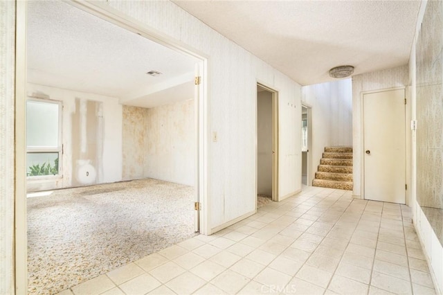 448 Via El Chico, Redondo Beach, CA 90277 - unfurnished room with a textured ceiling, stairs, light tile patterned flooring, and light carpet