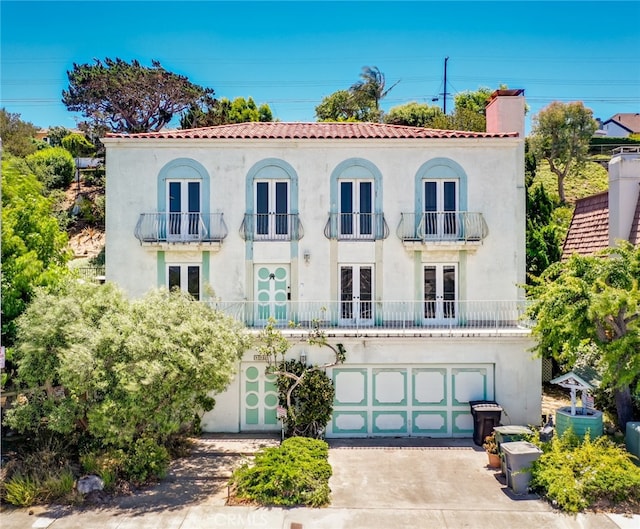 448 Via El Chico, Redondo Beach, CA 90277 - mediterranean / spanish-style home featuring french doors, a balcony, driveway, and stucco siding