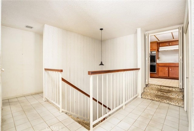 448 Via El Chico, Redondo Beach, CA 90277 - hall featuring an upstairs landing, a textured ceiling, and tile patterned flooring