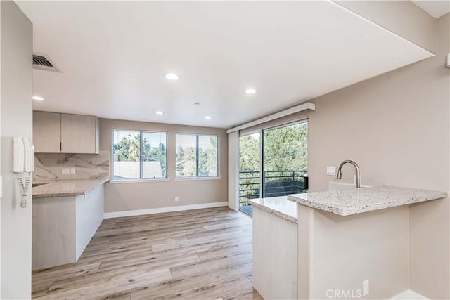 1742 Hanscom Dr, South Pasadena, CA 91030 - kitchen featuring a peninsula, healthy amount of natural light, light wood-style flooring, light stone countertops, and recessed lighting