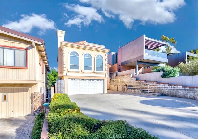 1742 Hanscom Dr, South Pasadena, CA 91030 - view of front of house with concrete driveway, a garage, and a chimney