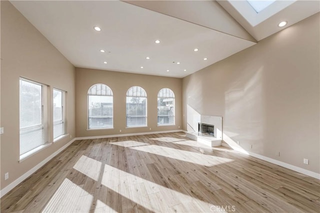 1742 Hanscom Dr, South Pasadena, CA 91030 - unfurnished living room featuring a skylight, a premium fireplace, light wood-type flooring, and recessed lighting