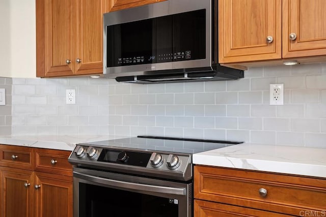 4763 Miletus Way, Oceanside, CA 92056 - kitchen featuring stainless steel appliances, backsplash, brown cabinets, and light stone countertops