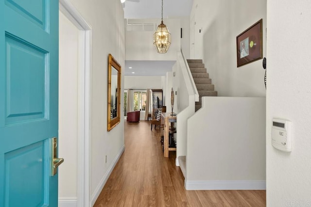 4763 Miletus Way, Oceanside, CA 92056 - entryway with wood finished floors, a chandelier, stairs, and a high ceiling