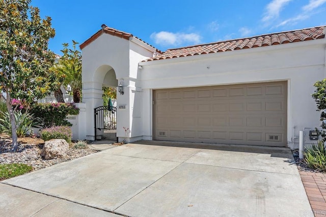 4763 Miletus Way, Oceanside, CA 92056 - mediterranean / spanish-style home with stucco siding, a tiled roof, a gate, driveway, and an attached garage