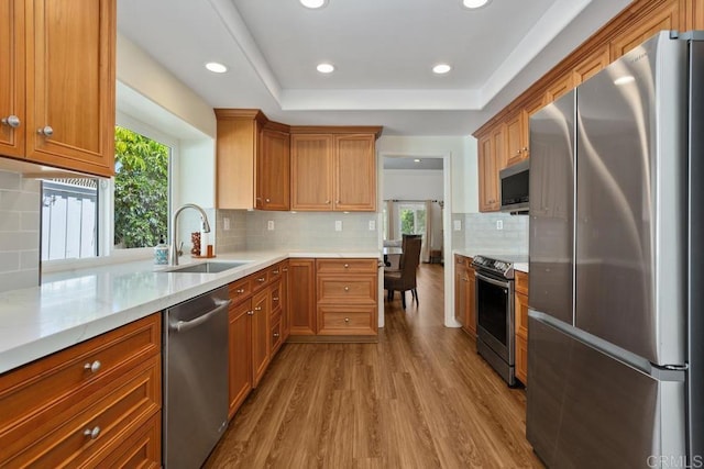4763 Miletus Way, Oceanside, CA 92056 - kitchen featuring stainless steel appliances, wood finished floors, recessed lighting, backsplash, and light stone counters