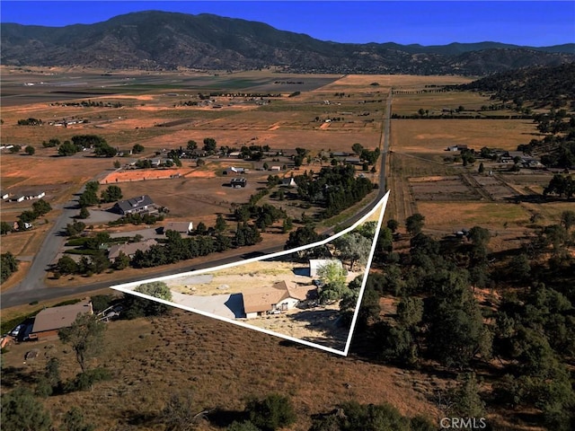 27861 Cummings Valley Rd, Tehachapi, CA 93561 - aerial view of property's location with a mountain backdrop, property boundaries highlighted, and rural landscape