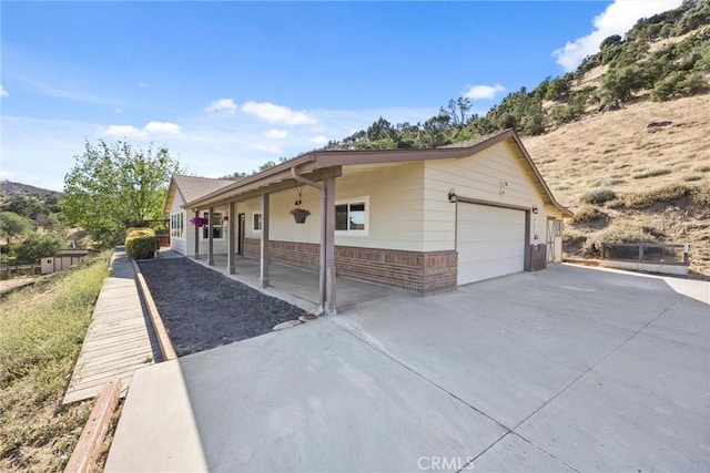 27861 Cummings Valley Rd, Tehachapi, CA 93561 - view of front of home featuring brick siding and concrete driveway