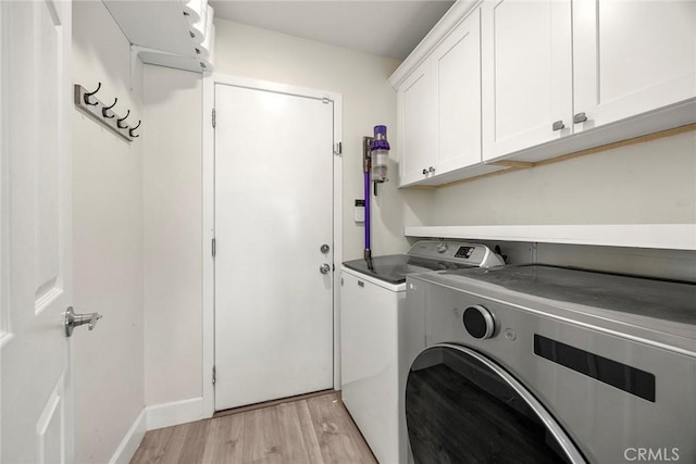 4021 Pikes Peak Dr, Norco, CA 92860 - laundry room with washer and clothes dryer, cabinet space, and light wood finished floors