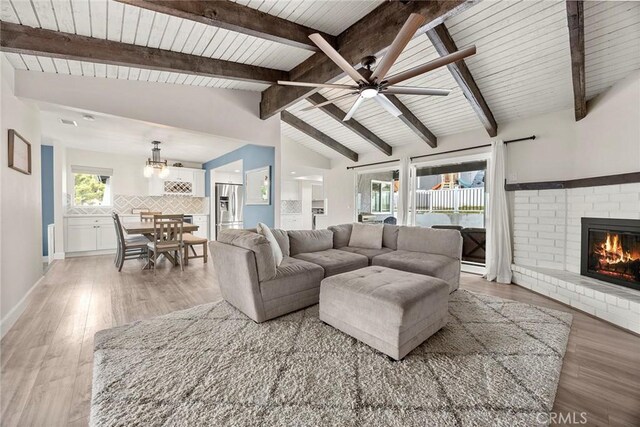 4021 Pikes Peak Dr, Norco, CA 92860 - living room featuring a fireplace, a ceiling fan, light wood-style flooring, a chandelier, and wood ceiling