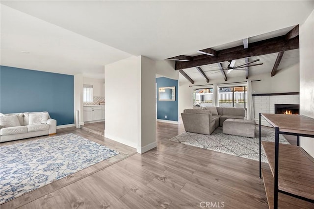 4021 Pikes Peak Dr, Norco, CA 92860 - living area featuring ceiling fan, a fireplace, and wood finished floors