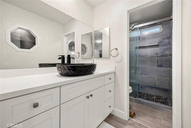 4021 Pikes Peak Dr, Norco, CA 92860 - bathroom featuring vanity, tiled shower, and wood finished floors