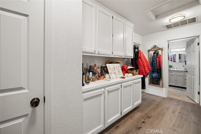 411 Spanish Moss Ln, Arroyo Grande, CA 93420 - kitchen with light wood finished floors, white cabinets, and light countertops