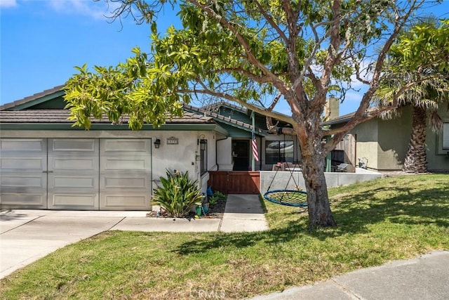 411 Spanish Moss Ln, Arroyo Grande, CA 93420 - view of front of house featuring stucco siding, concrete driveway, an attached garage, and a front yard