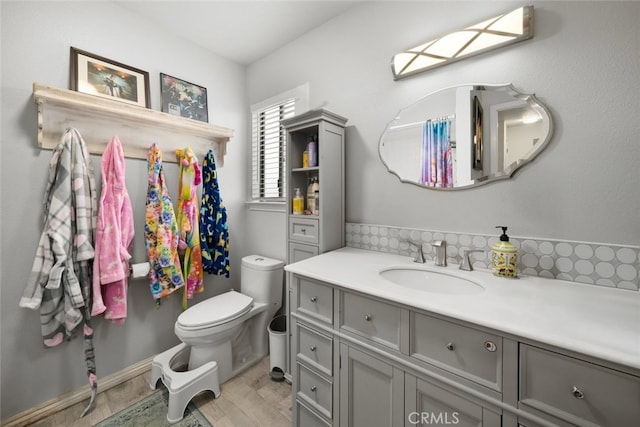 411 Spanish Moss Ln, Arroyo Grande, CA 93420 - bathroom with vanity, wood finished floors, and backsplash