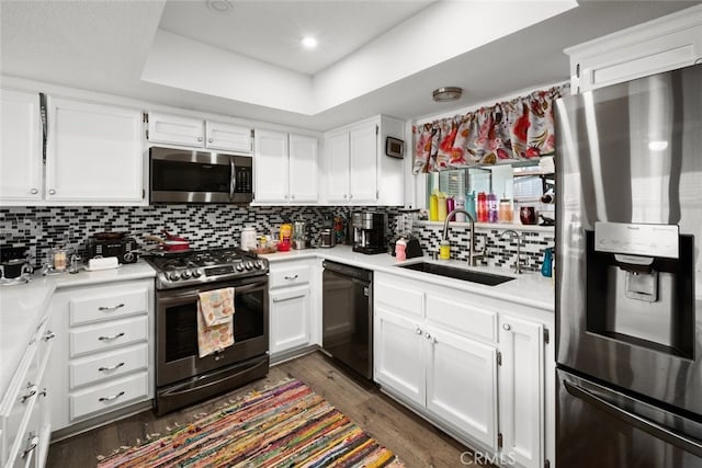 411 Spanish Moss Ln, Arroyo Grande, CA 93420 - kitchen featuring appliances with stainless steel finishes, light countertops, white cabinetry, and dark wood-type flooring