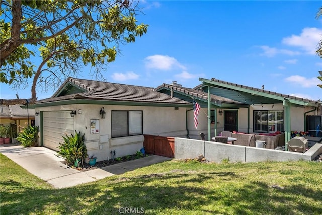 411 Spanish Moss Ln, Arroyo Grande, CA 93420 - rear view of property with an attached garage, a tile roof, a yard, and stucco siding