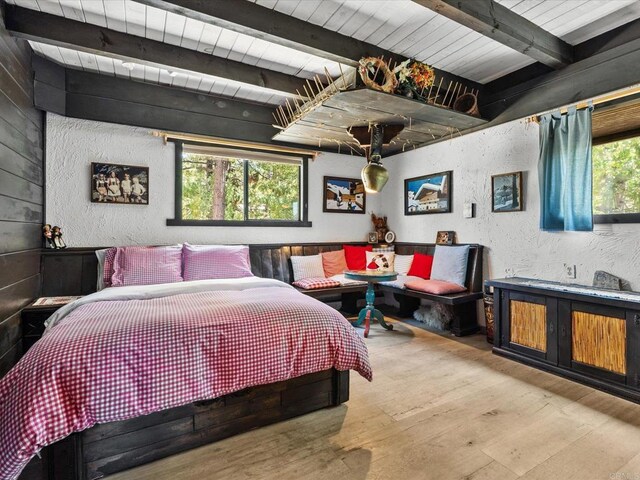 1082 Mountain Canary Dr, South Lake Tahoe, CA 96150 - bedroom featuring hardwood / wood-style floors, beam ceiling, and a textured wall