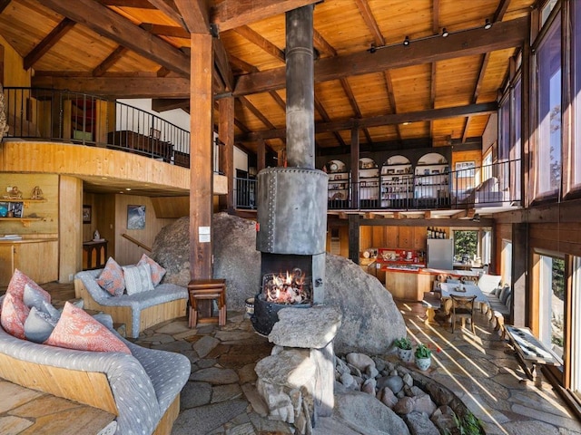 1082 Mountain Canary Dr, South Lake Tahoe, CA 96150 - living room with a wood ceiling with exposed beams, high vaulted ceiling, a high end fireplace, and wood walls