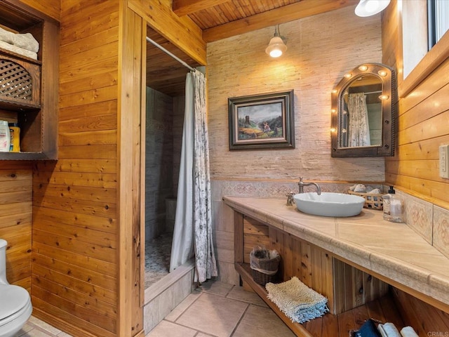 1082 Mountain Canary Dr, South Lake Tahoe, CA 96150 - bathroom with wood walls, curtained shower, vanity, tile patterned flooring, and a wooden ceiling with exposed beams