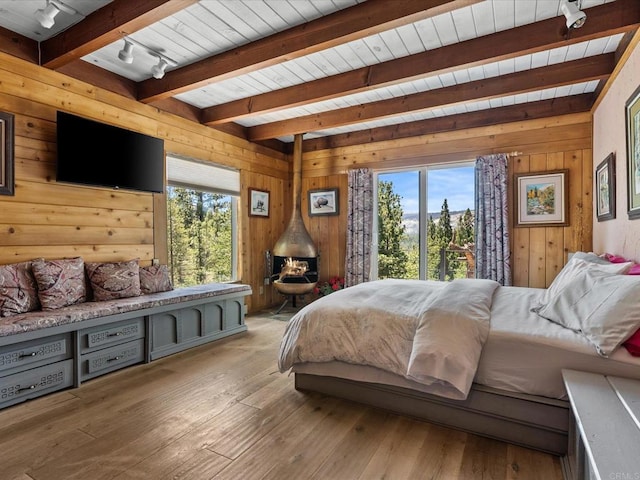 1082 Mountain Canary Dr, South Lake Tahoe, CA 96150 - bedroom with rail lighting, wooden walls, light wood finished floors, and a wooden ceiling with exposed beams