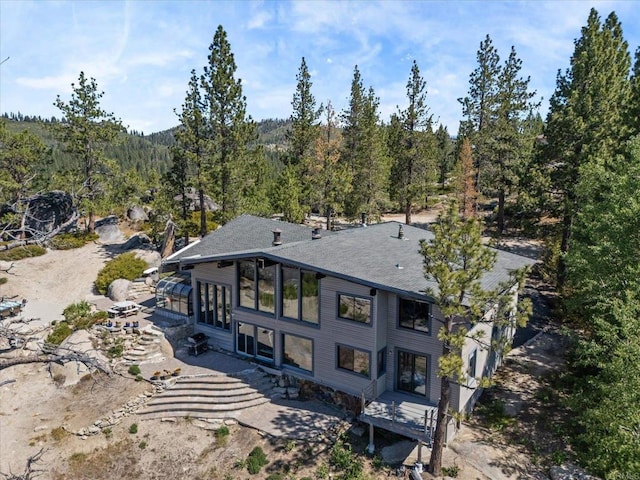 1082 Mountain Canary Dr, South Lake Tahoe, CA 96150 - rear view of house featuring a forest view and a sunroom