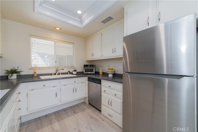 2245 Via Mariposa E Unit D, Laguna Woods, CA 92637 - kitchen with appliances with stainless steel finishes, a raised ceiling, dark countertops, recessed lighting, and ornamental molding