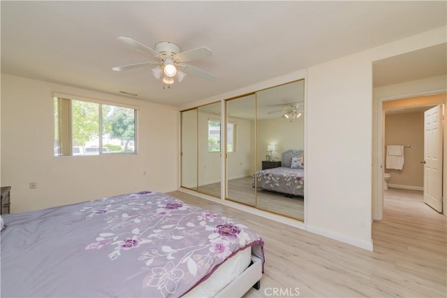 2245 Via Mariposa E Unit D, Laguna Woods, CA 92637 - bedroom with two closets, light wood-type flooring, and ceiling fan