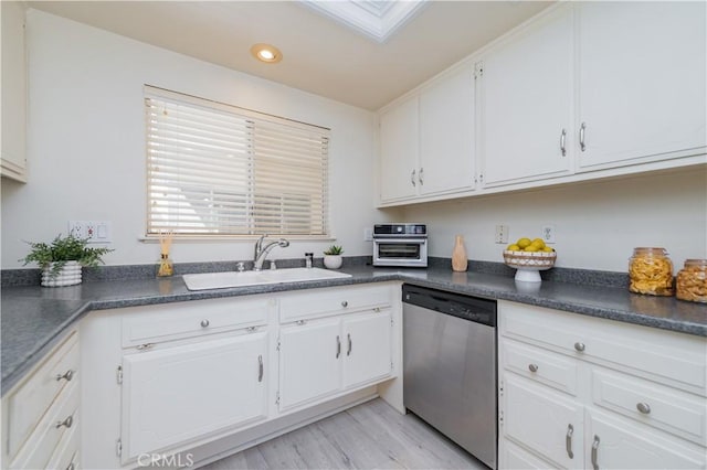 2245 Via Mariposa E Unit D, Laguna Woods, CA 92637 - kitchen featuring stainless steel dishwasher, dark countertops, white cabinetry, and recessed lighting