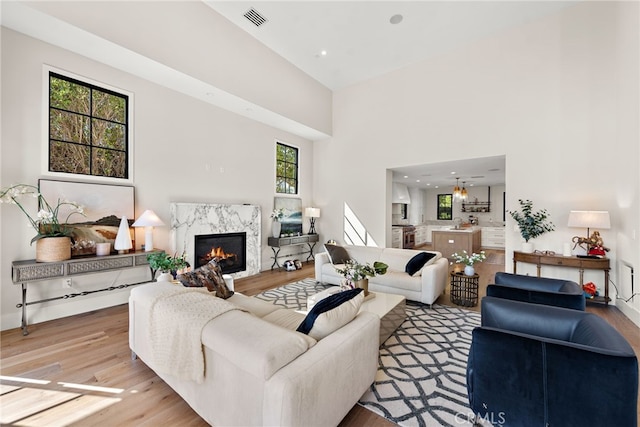 1963 Port Edward Pl, Newport Beach, CA 92660 - living room with wood finished floors, a high end fireplace, and a towering ceiling