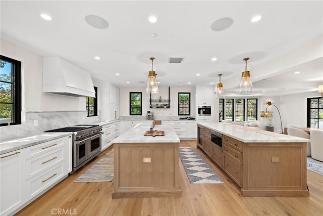 1963 Port Edward Pl, Newport Beach, CA 92660 - kitchen with a spacious island, custom exhaust hood, stainless steel appliances, open floor plan, and light wood-style floors