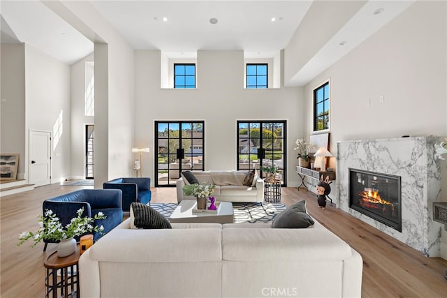 1963 Port Edward Pl, Newport Beach, CA 92660 - living room featuring wood finished floors, a fireplace, a towering ceiling, and recessed lighting