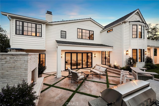 1963 Port Edward Pl, Newport Beach, CA 92660 - back of house featuring a patio area, an outdoor living space, and a chimney