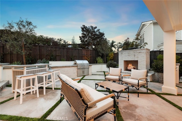 1963 Port Edward Pl, Newport Beach, CA 92660 - fenced backyard featuring a patio area, exterior kitchen, and an outdoor living space with a fireplace