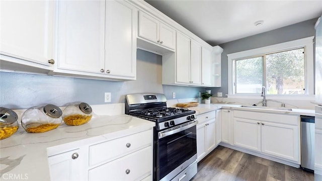 243 N Verdugo Rd, Glendale, CA 91206 - kitchen with stainless steel appliances, white cabinetry, light stone counters, and wood finished floors