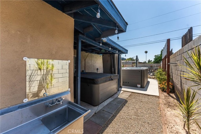 1504 Valaria Dr, Highland, CA 92346 - view of side of home featuring a hot tub, a fenced backyard, and stucco siding