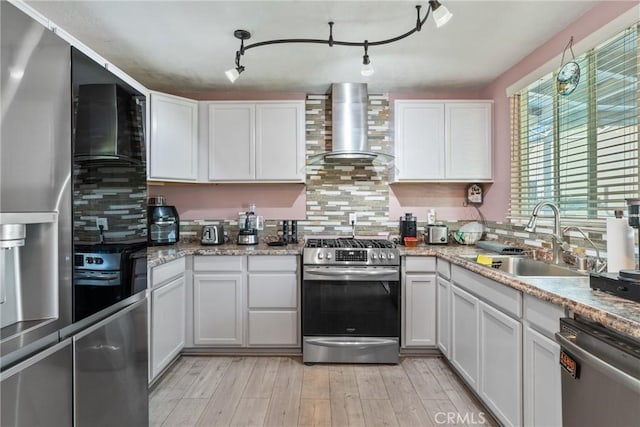 1504 Valaria Dr, Highland, CA 92346 - kitchen featuring stainless steel appliances, wall chimney exhaust hood, white cabinetry, and decorative backsplash