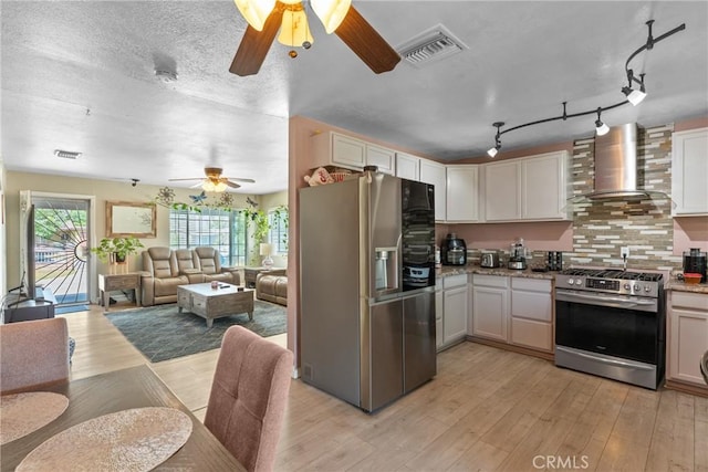 1504 Valaria Dr, Highland, CA 92346 - kitchen with appliances with stainless steel finishes, wall chimney exhaust hood, ceiling fan, open floor plan, and light wood-style floors