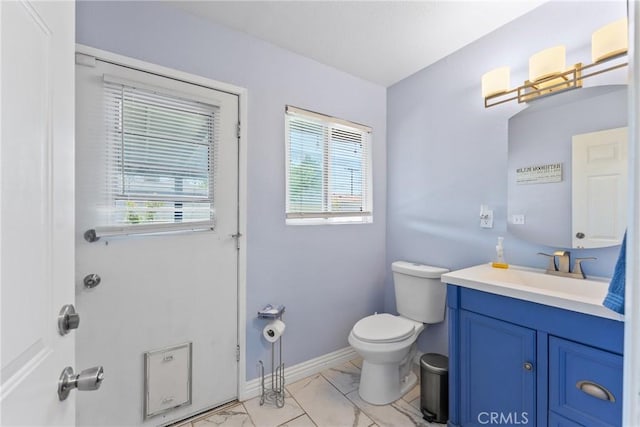 1504 Valaria Dr, Highland, CA 92346 - bathroom featuring marble look tile flooring, vanity, and healthy amount of natural light
