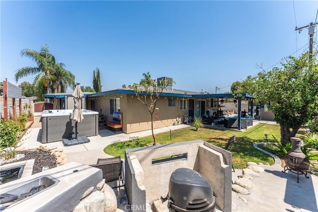 1504 Valaria Dr, Highland, CA 92346 - rear view of property with a hot tub, a patio area, an outdoor living space with a fire pit, and stucco siding