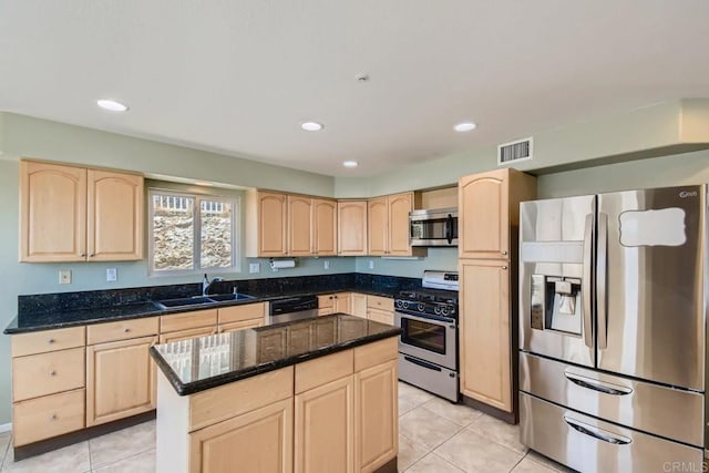 1413 San Miguel Ave, Spring Valley, CA 91977 - kitchen with stainless steel appliances, light brown cabinetry, light tile patterned flooring, dark stone countertops, and recessed lighting