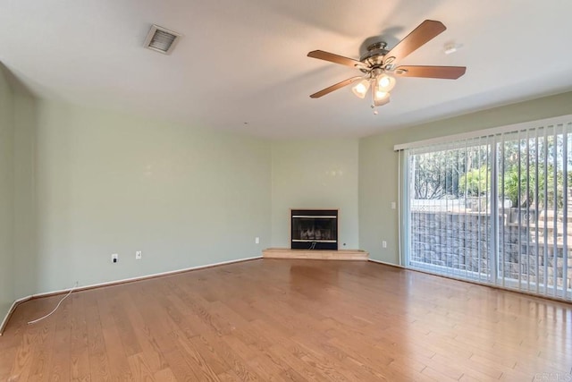 1413 San Miguel Ave, Spring Valley, CA 91977 - unfurnished living room featuring wood finished floors, a ceiling fan, and a glass covered fireplace