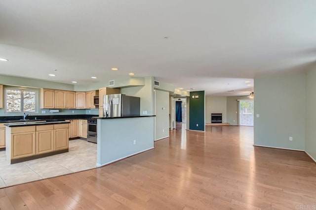1413 San Miguel Ave, Spring Valley, CA 91977 - kitchen with appliances with stainless steel finishes, light wood-type flooring, dark countertops, light brown cabinets, and recessed lighting