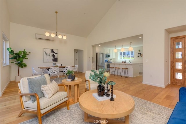 5351 Filbert St, Paradise, CA 95969 - living room with light wood-style flooring, an AC wall unit, and high vaulted ceiling