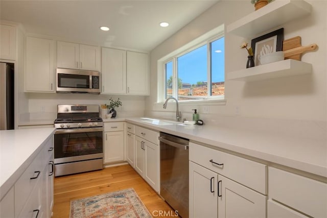 5351 Filbert St, Paradise, CA 95969 - kitchen with appliances with stainless steel finishes, recessed lighting, white cabinetry, light wood-style floors, and light countertops
