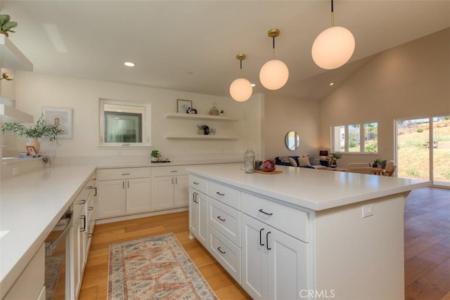 5351 Filbert St, Paradise, CA 95969 - kitchen featuring light wood-type flooring, white cabinets, recessed lighting, open shelves, and a kitchen island